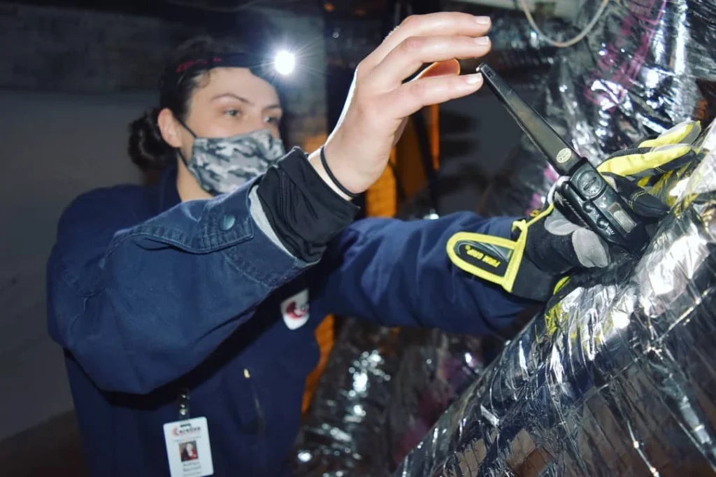 Technician installing ducts