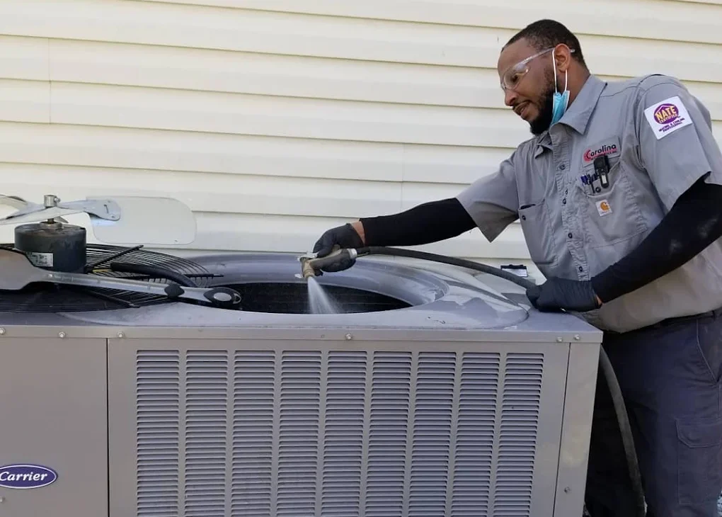 CHS technician cleaning an AC unit
